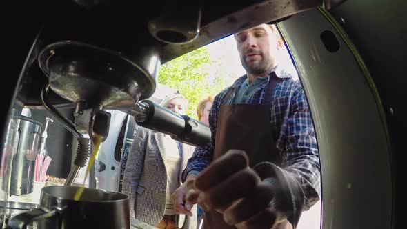 Male Barista Making Coffee Outside