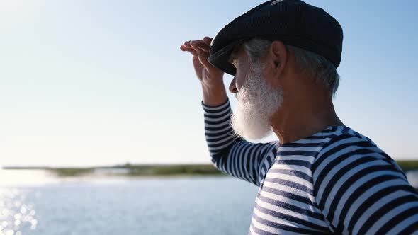 Portrait of an Old Man with a White Beard Looking Into the Distance on the Seashore or Ocean