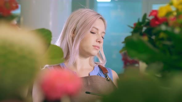 Young Woman Florist with Fair Hair Conducting Inspection