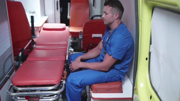 Unhappy Corpsman Sit in Ambulance Car.