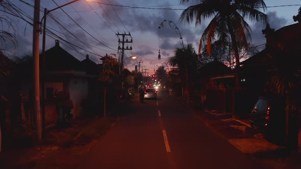 Street View of City Traffic in Tropical Bali Streets During Sunset