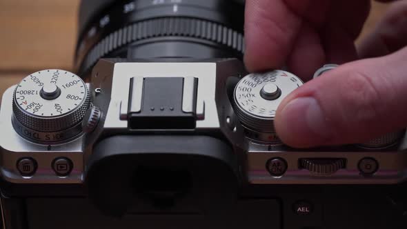 Man's Hands Turn the Aperture Wheel on a Vintage Camera Closeup