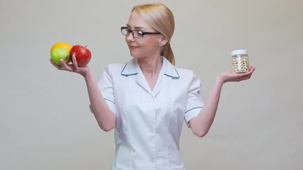 Nutritionist Doctor Healthy Lifestyle Concept - Holding Natural Organic Fruits and Can of Pills