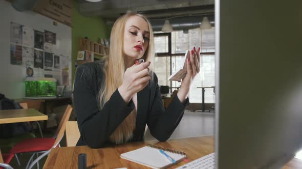 Business Woman Looking in the Mirror and Using Lipstick at Her Worlplace in Office Dolly Shot