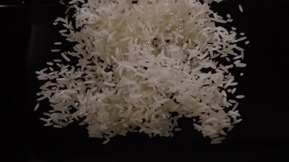 White Rice Falls into Water - The Process of Cooking Rice