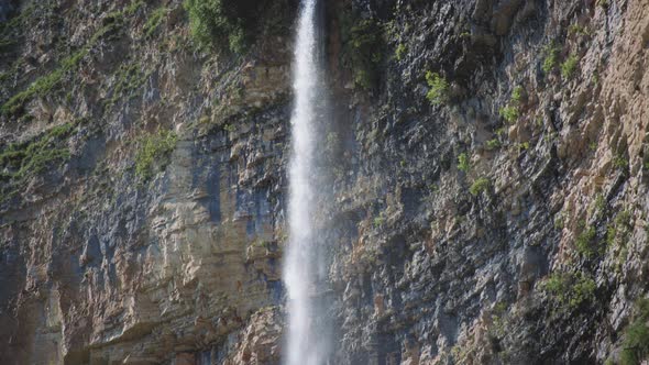 High waterfall splashing from the cliff