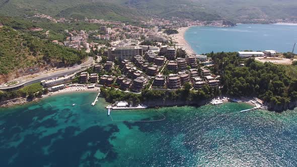 Dukley Hotel on the Sea Coast of Budva with Mountains in the Background