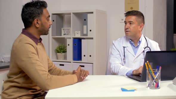 Male Doctor with Laptop Talking To Patient 18