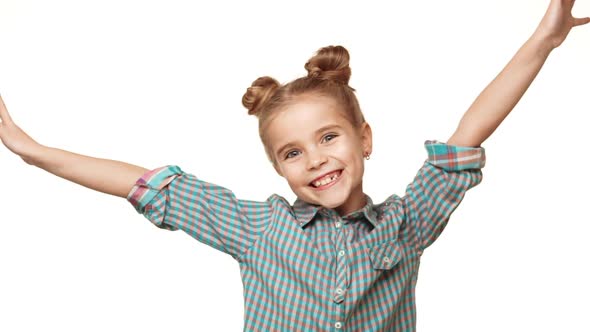 Beautiful Charming Young Caucasian Girl Kid in Plaid Shirt Jumping and Smiling on White Background