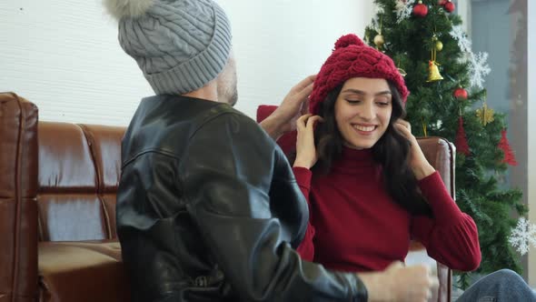 Man wearing hat on woman head