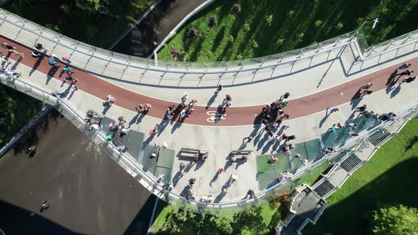 Aerial Top View of Pedestrian Glass Bridge with a Crowd of Walking People