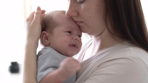 Mommy Tries to Calm the Crying Baby Shakes Him in Her Arms Dissatisfied Crying Upset Sad Newborn