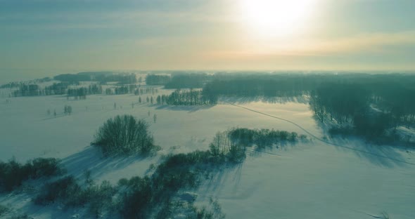 Aerial View of Cold Winter Landscape Arctic Field Trees Covered with Frost Snow Ice River and Sun