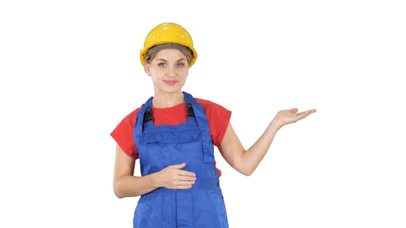 Young builder worker woman presenting showing product with