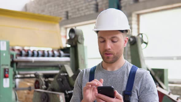 A Professional Worker in the Industrial Workshop Manages Production