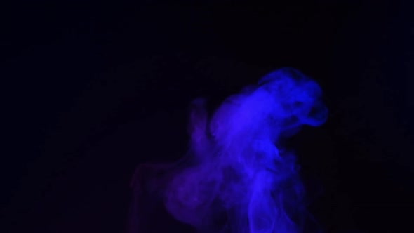 Slow motion of blue smoke, fog, mist, vapor on a black background.