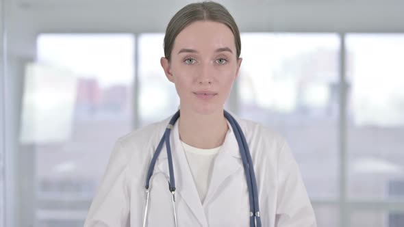 Portrait of Smiling Young Female Doctor Looking at the Camera