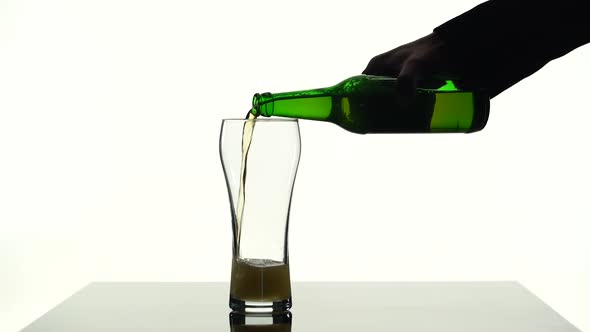 Beer Is Pouring Into a Glass That Is on the Table