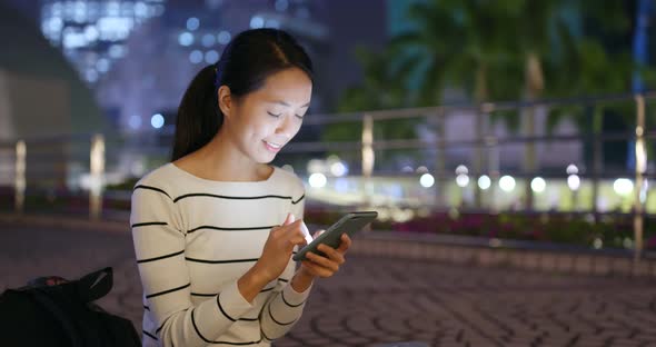 Woman use of smart phone in city