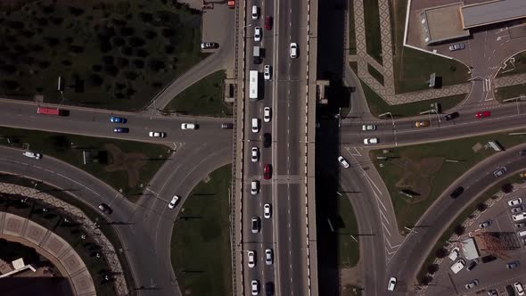 Drone's Eye View -  Overhead Top Down View Of Traffic Driving Over A Modern Bridge