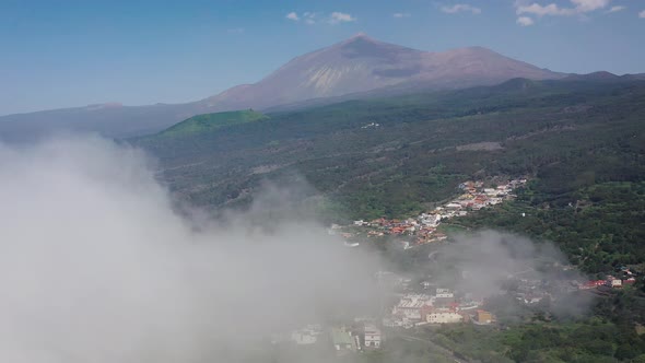 Flying Through the Clouds Over the Island of Tenerife - a View of the Settlements and the Teide