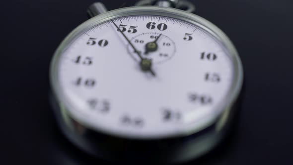 Macro shot of a classic metallic retro mechanical analog stopwatch