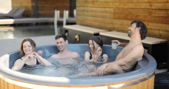 Friends Having Fun Bathing at Spa Outdoors