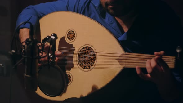Man Playing a Lute in Studio