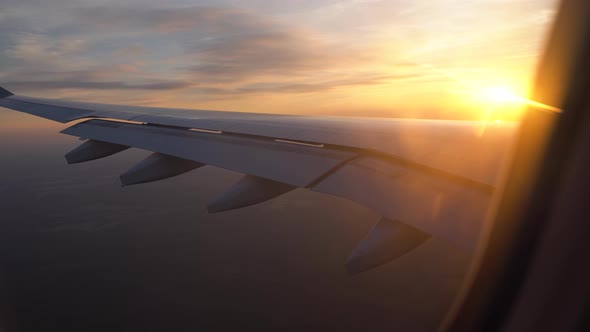 Sunset in the Window of the Plane. Beautiful View of the Aircraft Wing. Passenger Transportation and