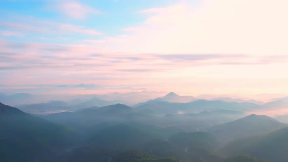 4K Flying through the clouds above mountain tops