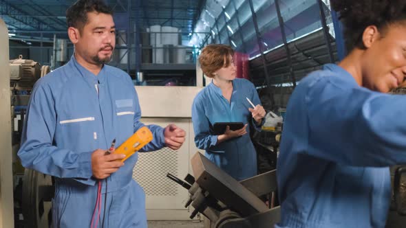 Engineer teams inspect machines' electric current at the industry factory.