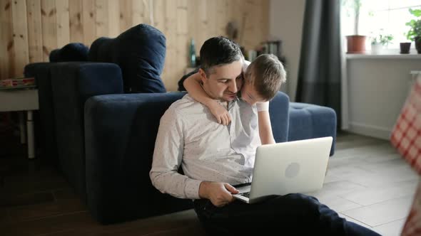 Dad and Son Are Doing Homework Together on Laptop Distance Education Lockdown