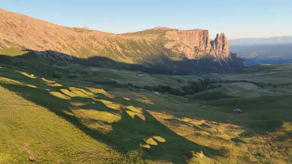 Dolomites mountains peaks with a hiking path on a summer sunrise