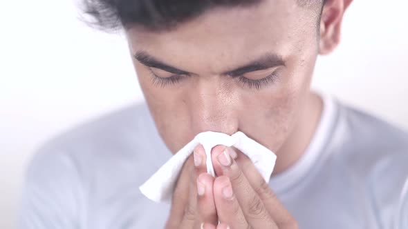 Sick Man with Flu Blow Nose with Napkin