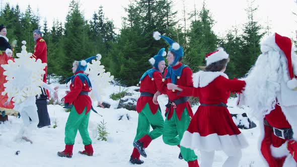 Santa and his helpers dancing alt