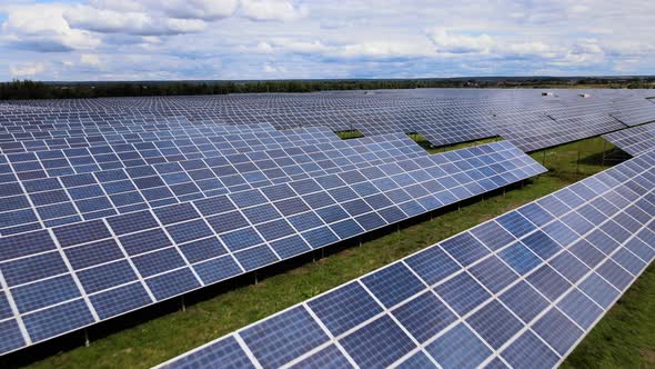 Aerial View of Big Sustainable Electric Power Plant with Many Rows of Solar Photovoltaic Panels for