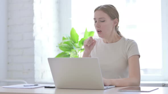 Woman Coughing While Working on Laptop