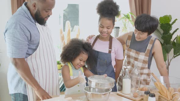 African America family wearing apron for cooking bakery or bread with flour together in the kitchen.