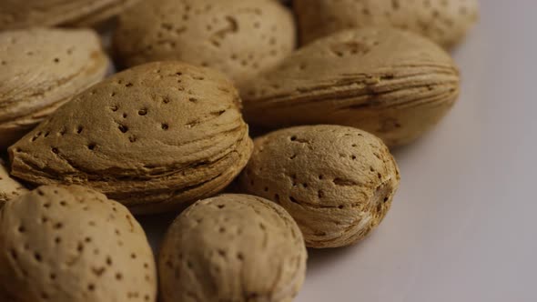 Cinematic, rotating shot of almonds on a white surface -