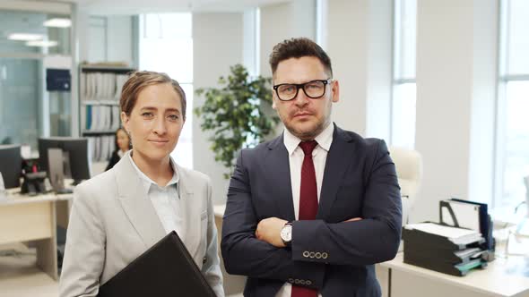 Portrait of Businessman and Businesswoman in Office