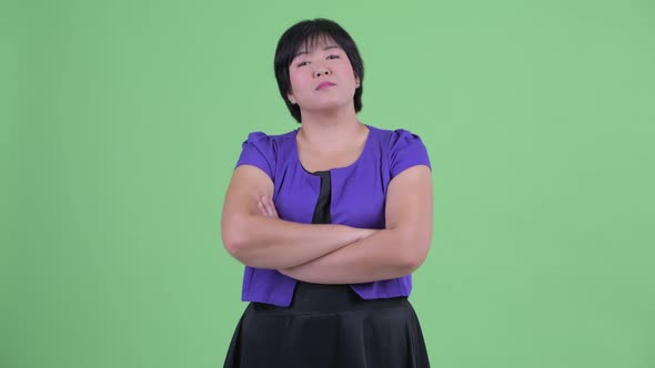 Happy Young Beautiful Overweight Asian Woman Smiling with Arms Crossed