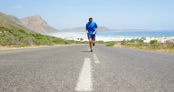 Triathlete man jogging in the countryside road