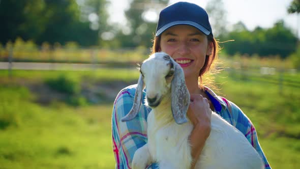 Woman Visitor of Farm is Holding Little Boer Goat  Ecotourism in Cattle Farm