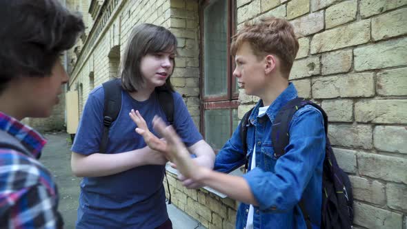 Aggressive Classmates Bullying Frightened Redhead Nerd on Schoolyard. Side View Portrait of Violent