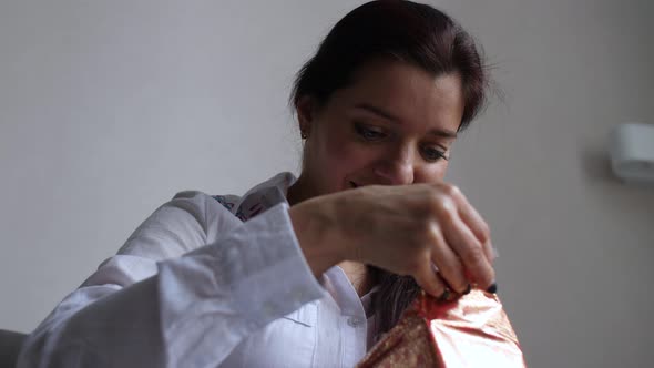 Girl at Home Fiddling with Gifts