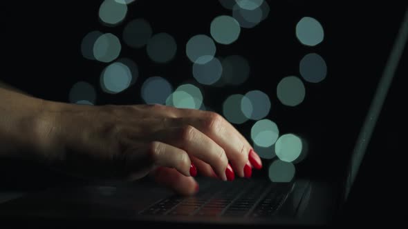 Female Hands Is Typing on a Laptop at Night