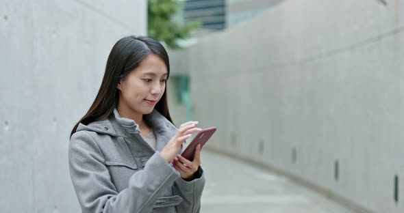 Woman work on smart phone in city