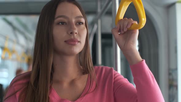 Young Woman Passenger Enjoying Trip at the Public Transport, Standing in the Modern Tram.