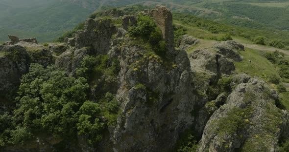 Daytime panorama of the Azeula Fortress ruins and its natural surroundings.