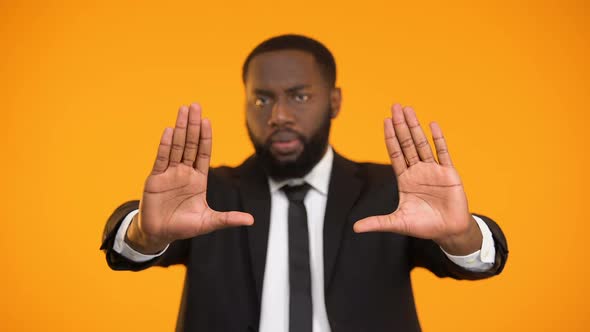 Afro-American Man in Business Suit Making Stop Gesture, No Racism and Inequality